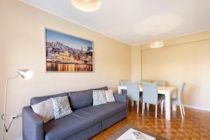 a living room with a couch and a table at Destiny Oporto in Maia