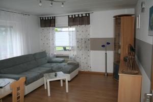 a living room with a couch and a table at Ferienwohnung Sammet in Brilon
