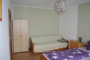a small bedroom with a bed and a cabinet at Ferienwohnung Sammet in Brilon