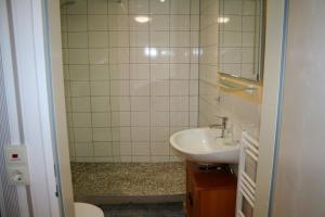 a bathroom with a sink and a mirror at Ferienwohnung Sammet in Brilon +10 photos
