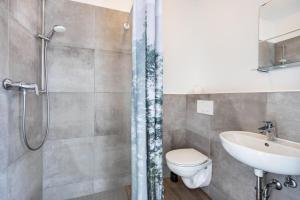 a bathroom with a shower and a toilet and a sink at Himmelpforten Loft in Himmelpforten +15 photos