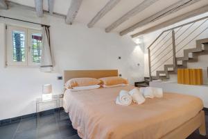 a bedroom with a large bed with towels on it at La Guardiola I By Immobilux in Riva del Garda