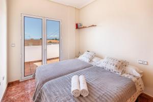 a bedroom with a large bed and a large window at Primera Planta in Cartagena +16 photos