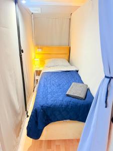 a small bedroom with a bed in a tent at Новый Хостел с Кабинками in Chişinău