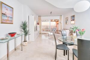 a living room with a glass table and chairs at Beautiful Penthouse in Torrox Costa