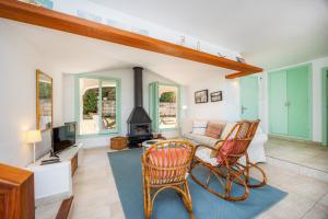 a living room with a couch and a fireplace at Can Botana 9 in Cala de Sant Vicenc
