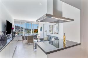 a kitchen and living room with a couch and a table at Brisas Canarias in Puerto Rico de Gran Canaria
