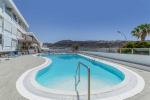 a swimming pool on the side of a building at Brisas Canarias in Puerto Rico de Gran Canaria