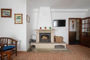 a living room with a fireplace and a tv at Casa De Marica in A Estrada