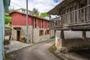 an old building with a bridge over a street at Casa Rural Adrimar in Selorio