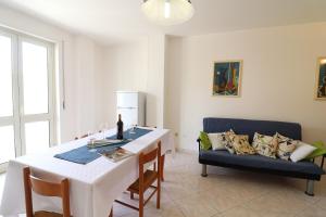 a living room with a table and a couch at Casa Vacanze Marta in Otranto +20 photos