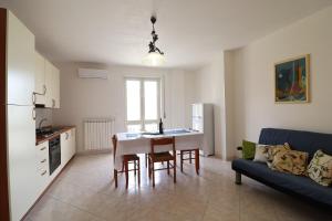 a kitchen and living room with a table and a couch at Casa Vacanze Marta in Otranto