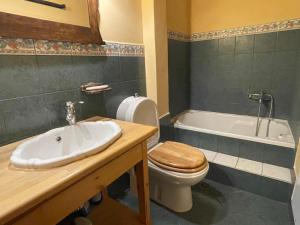a bathroom with a sink and a toilet and a tub at Traditional Stone House in Lazaráta