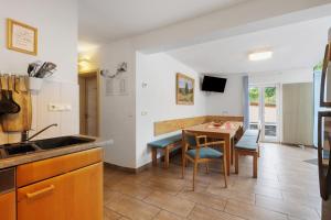 a kitchen with a table and a dining room at Ferienhaus Eifel Atrium in Zweifelscheid