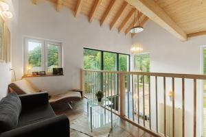a living room with a couch and a table at Ferienhaus Eifel Atrium in Zweifelscheid