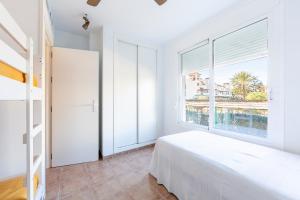 a bedroom with a bed and a large window at Apartamento Luz De Baria in Vera +22 photos