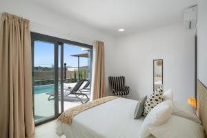 a bedroom with a bed and a balcony with a pool at Yucas Villa 13 in San Bartolomé +19 photos