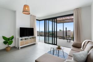 a living room with a tv and a couch at Yucas Villa 13 in San Bartolomé
