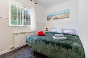 a bedroom with a large bed with two pillows on it at Masía Costa Daurada in Tarragona