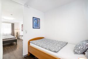 a small bedroom with a bed and a table at Die Schneiderei in Balingen