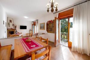a kitchen and dining room with a table and chairs at Maison Lorent in Champdepraz