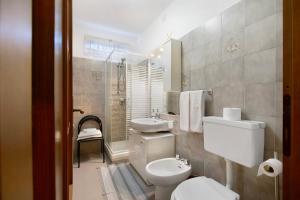a bathroom with a toilet and a sink at Maison Lorent in Champdepraz +19 photos