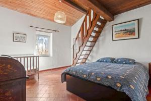 a bedroom with a bed and a staircase at Véritable Mas Provençal À La Palud in La Palud-sur-Verdon