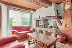 a living room with a couch and a fireplace at Véritable Mas Provençal À La Palud in La Palud-sur-Verdon