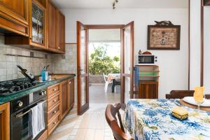 a kitchen with a table and a dining room at Al mare da Pépé in Budoni +16 photos