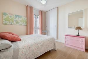 a bedroom with a bed and a dresser and a window at beach and pool in Cambrils +24 photos