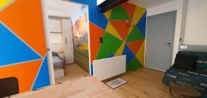 a room with a mural on the wall at Appartement La Perle Du Sancy in La Bourboule