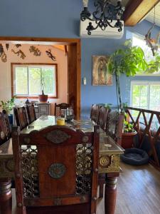 a dining room with a table and chairs at Casa Selva Escondida in Los Altos de Cerro Azul