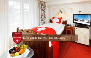 A bed or beds in a room at Hotel Walliserhof - The Dom Collection