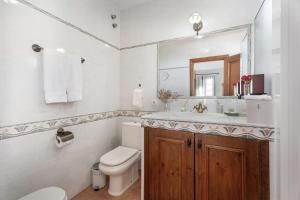 a bathroom with a toilet and a sink and a mirror at Villa María in Taco +26 photos