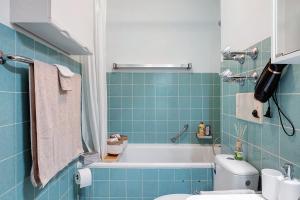 a blue bathroom with a tub and a toilet at Quality Time auf 1000 Meter in Schönwald +30 photos