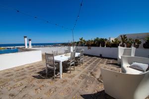 a patio with a table and chairs and the beach at C-Home Historic House in Otranto