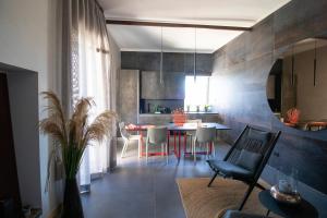 a kitchen and dining room with a table and chairs at C-Home Historic House in Otranto