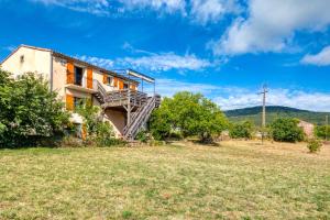 a house with a staircase on the side of it at La Trêve in La Tour-sur-Orb