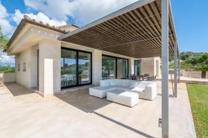 a patio of a house with white furniture at Dalt Son Morro in Santa Margalida