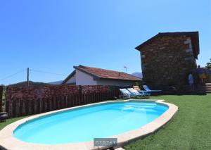 a swimming pool in the yard of a house at Casa Alto Das Fragas in Canedo de Basto