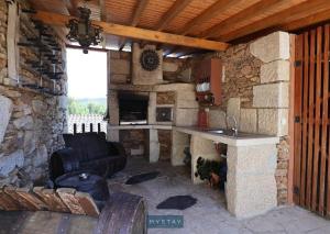 a kitchen in a stone building with a sink at Casa Alto Das Fragas in Canedo de Basto