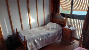 a bedroom with a bed and a table and a window at Casa Alto Das Fragas in Canedo de Basto