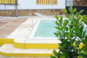 a pool in a yard with a water fountain at Refúgio Paraíso in Santo Amaro