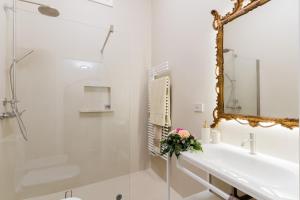 a white bathroom with a mirror and a sink at Bacchus Historic Home in Otranto +18 photos