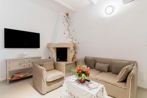 a living room with two couches and a tv at Bacchus Historic Home in Otranto