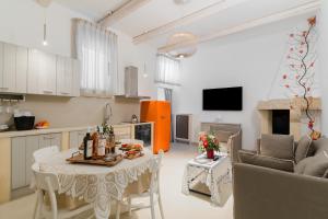 a kitchen and living room with a table and a couch at Bacchus Historic Home in Otranto