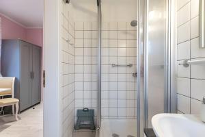 a bathroom with a shower and a sink at Ferienwohnung Wencke in Büsum +8 photos