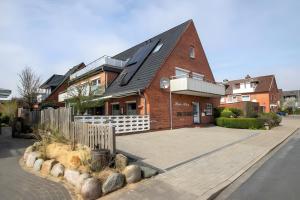 a red brick house with a black roof at Ferienwohnung Wencke in Büsum