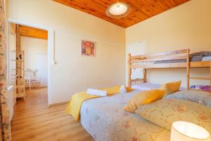 a bedroom with two beds and a wooden ceiling at Gîte Le Chant Des Oiseaux in Pradons +25 photos