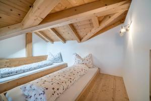 a bed in a room with wooden ceilings at Eggerhof Familiennestl in Verano